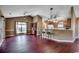 Open-concept living room featuring hardwood floors, modern lighting, and seamless kitchen access at 1154 Lampwick Ln., Murrells Inlet, SC 29576