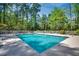 Community swimming pool surrounded by lounge chairs and tall trees at 1154 Lampwick Ln., Murrells Inlet, SC 29576
