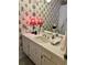Charming bathroom with colorful floral wallpaper, vintage lighting, and a white vanity at 116 Green Lake Dr., Myrtle Beach, SC 29572
