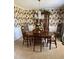 Elegant dining room with floral wallpaper, chandelier, and a wooden dining set at 116 Green Lake Dr., Myrtle Beach, SC 29572