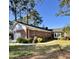 Charming brick home featuring a well-manicured lawn, screened porch, and attached garage at 116 Green Lake Dr., Myrtle Beach, SC 29572