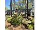 Charming brick home with lush landscaping, mature trees, and attached garage at 116 Green Lake Dr., Myrtle Beach, SC 29572