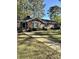 Quaint brick home featuring a walkway, manicured lawn, and vibrant flowering bushes at 116 Green Lake Dr., Myrtle Beach, SC 29572