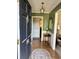 Inviting foyer featuring vertical striped wallpaper, wood floors and a stylish hanging light fixture at 116 Green Lake Dr., Myrtle Beach, SC 29572