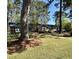 Traditional brick home with well-manicured lawn and mature trees provides great curb appeal at 116 Green Lake Dr., Myrtle Beach, SC 29572