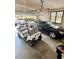 Spacious garage featuring a golf cart, multiple cars, and an automatic door at 116 Green Lake Dr., Myrtle Beach, SC 29572