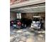 Functional garage featuring a car, golf cart, tools, and an open automatic door at 116 Green Lake Dr., Myrtle Beach, SC 29572