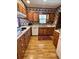 Charming kitchen with knotty pine cabinets, appliances, and hardwood floors at 116 Green Lake Dr., Myrtle Beach, SC 29572