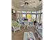 Bright sun room featuring lots of windows, a glass top table, and wicker furniture at 116 Green Lake Dr., Myrtle Beach, SC 29572