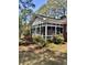 Bright sunroom with exterior brick accents, surrounded by lush landscaping and mature trees at 116 Green Lake Dr., Myrtle Beach, SC 29572