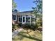 Bright sunroom with brick accents, surrounded by lush landscaping, offering a serene retreat at 116 Green Lake Dr., Myrtle Beach, SC 29572