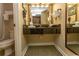 The bathroom has a floating granite vanity and gold trimmed mirror at 1200 N Ocean Blvd. N # 905, Myrtle Beach, SC 29577