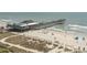 Beach view featuring the pier with people gathering and enjoying the ocean breeze at 1200 N Ocean Blvd. N # 905, Myrtle Beach, SC 29577