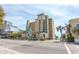 Attractive view of the Holiday Pavilion building showcasing architectural features and proximity to palm trees and the street at 1200 N Ocean Blvd. N # 905, Myrtle Beach, SC 29577