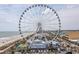 Stunning view of the SkyWheel ferris wheel, beach, and cityscape highlighting the property's location at 1200 N Ocean Blvd. N # 905, Myrtle Beach, SC 29577