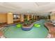 Indoor lazy river with lush greenery, lounge chairs, and shallow water at 1200 N Ocean Blvd. N # 905, Myrtle Beach, SC 29577
