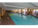 Large indoor pool with shallow water and lounge chairs surrounding the pool deck at 1200 N Ocean Blvd. N # 905, Myrtle Beach, SC 29577