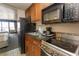 Fully equipped kitchen space with appliances and granite counters, adjacent to a room with two beds at 1200 N Ocean Blvd. N # 905, Myrtle Beach, SC 29577