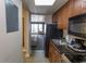Compact kitchen featuring granite countertops, a sink, and views into the hotel room at 1200 N Ocean Blvd. N # 905, Myrtle Beach, SC 29577