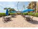 Inviting outdoor seating area with tables, chairs, and umbrellas, perfect for relaxation and enjoying the surroundings at 1200 N Ocean Blvd. N # 905, Myrtle Beach, SC 29577