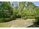 Lush backyard with mature trees and green grass, providing a private and serene outdoor space at 121 Olde Towne Way # 2, Myrtle Beach, SC 29588