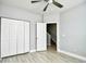 This bedroom features a ceiling fan, closet, light gray walls and wood-look flooring at 121 Olde Towne Way # 2, Myrtle Beach, SC 29588