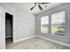 Bedroom with a ceiling fan, two windows and light gray walls and wood-look flooring at 121 Olde Towne Way # 2, Myrtle Beach, SC 29588