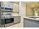 Updated kitchen with stainless steel appliances, gray cabinets, and marble countertops at 121 Olde Towne Way # 2, Myrtle Beach, SC 29588