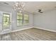 Bright living room featuring new vinyl flooring, modern lighting and an exterior door at 121 Olde Towne Way # 2, Myrtle Beach, SC 29588