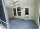 Screened porch featuring fan, windows, and vinyl siding and stone-look flooring at 121 Olde Towne Way # 2, Myrtle Beach, SC 29588