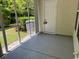 Cozy screened porch with stone-look flooring and exterior door at 121 Olde Towne Way # 2, Myrtle Beach, SC 29588