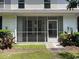 Charming screened porch with white trim and a tranquil view, offering a relaxing outdoor space at 121 Olde Towne Way # 2, Myrtle Beach, SC 29588