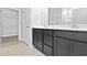 Bathroom featuring tile floor, dark cabinets with dual sinks, a mirror, and a doorway to the closet at 1226 Nw Calabash Station Blvd., Calabash, NC 28467
