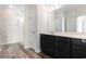 Bathroom features a double sink vanity with dark cabinets and a large mirror at 1233 Cypress Shoal Dr., Conway, SC 29526