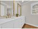 Bright bathroom with a dual sink vanity with modern gold hardware and framed mirrors at 129 Old Cedar Loop, Pawleys Island, SC 29585