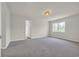 Spacious bedroom with carpet flooring, neutral paint, window, and designer light fixture at 129 Old Cedar Loop, Pawleys Island, SC 29585