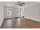 Spacious bedroom featuring wood floors, neutral walls, and ample natural light from large windows at 129 Old Cedar Loop, Pawleys Island, SC 29585