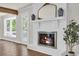 Beautiful fireplace with white painted brick and rustic mantel at 129 Old Cedar Loop, Pawleys Island, SC 29585