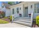 Inviting front porch features classic design elements with upgraded lighting and landscaping at 129 Old Cedar Loop, Pawleys Island, SC 29585