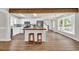 Spacious open kitchen with butcher block breakfast bar, white cabinets, and stainless fridge at 129 Old Cedar Loop, Pawleys Island, SC 29585