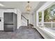 A modern kitchen offers stainless appliances, stone floors, and a large bay window for natural light at 129 Old Cedar Loop, Pawleys Island, SC 29585
