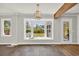 Bright living room with large bay window offering scenic backyard views and a stylish, modern light fixture at 129 Old Cedar Loop, Pawleys Island, SC 29585