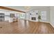 Open-concept living room with wood-look flooring, fireplace, and access to kitchen and deck at 129 Old Cedar Loop, Pawleys Island, SC 29585