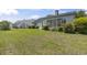 The backyard features a well-maintained lawn, mature landscaping, and partial view of the home's exterior at 1406 Snowy Egret Dr., Murrells Inlet, SC 29576