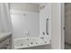 Bathroom with soaking tub and white tiled walls offers a relaxing retreat at 1406 Snowy Egret Dr., Murrells Inlet, SC 29576