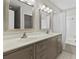 Bright bathroom features double vanity, framed mirrors, and a shower-tub combo at 1406 Snowy Egret Dr., Murrells Inlet, SC 29576