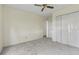 Neutral bedroom with ceiling fan, plush carpet, and double door closet at 1406 Snowy Egret Dr., Murrells Inlet, SC 29576