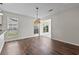 Dining area featuring hardwood floors, window and view to sunroom at 1406 Snowy Egret Dr., Murrells Inlet, SC 29576