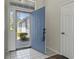 Bright foyer with white tiled flooring and a blue front door welcomes you inside at 1406 Snowy Egret Dr., Murrells Inlet, SC 29576
