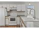 The kitchen offers plenty of counter space, appliances, and white cabinetry at 1406 Snowy Egret Dr., Murrells Inlet, SC 29576